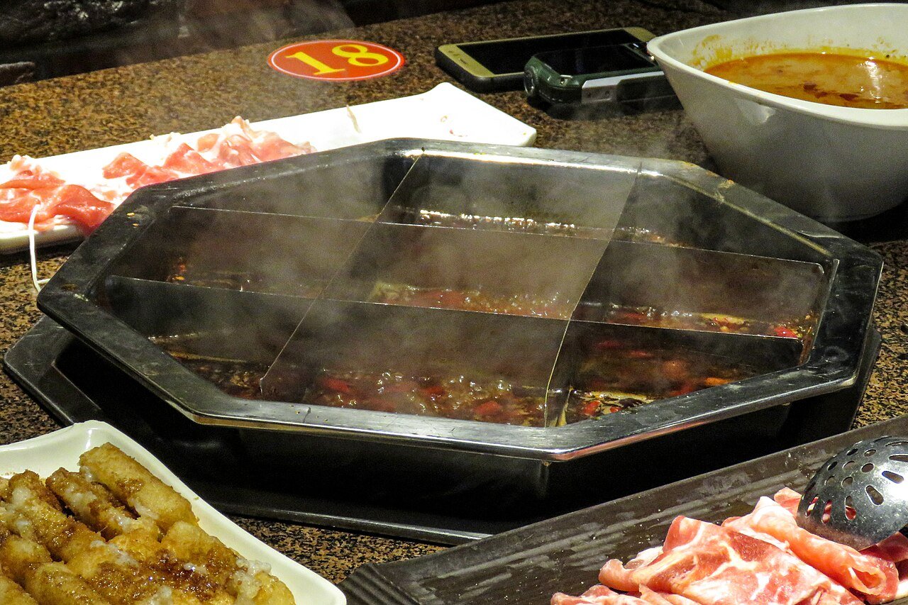 A nine-grid Chongqing hotpot with spicy broth and ingredients