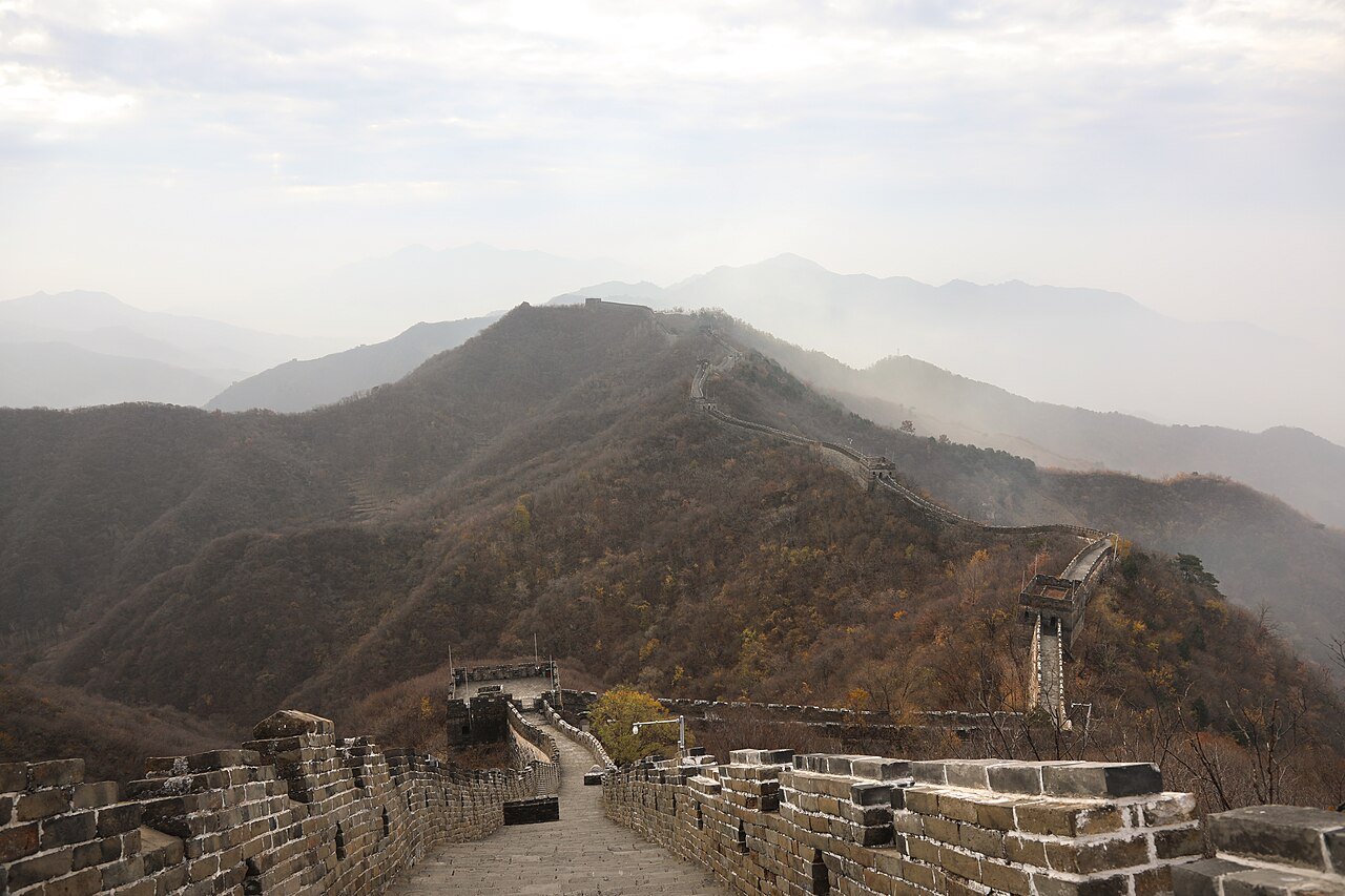 Late autumn at Mutianyu, watchtowers receding along the ridge in hazy light