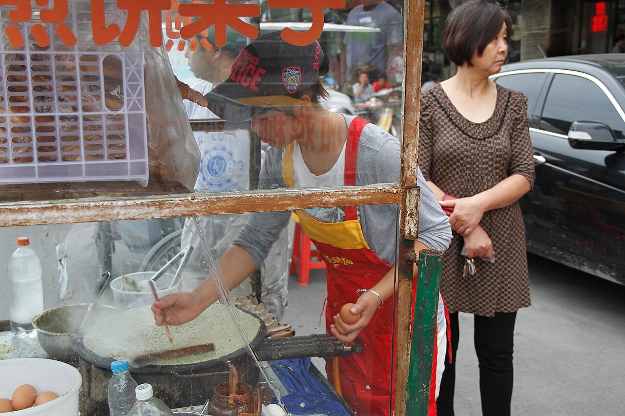 Street vendor preparing jianbing guozi in Tianjin